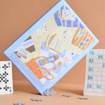 Puzzle 500 pièces "Du sable entre les pages" - Boutique We Are ParisJour Férié