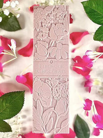 Tablette de chocolat blanc enfleurage à la rose de Damas. - Boutique We Are ParisFleurs de chocolats